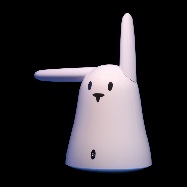 White Nabaztag rabbit robot with two upright ears and a rounded base, photographed against a neutral background at the Musée Bolo.