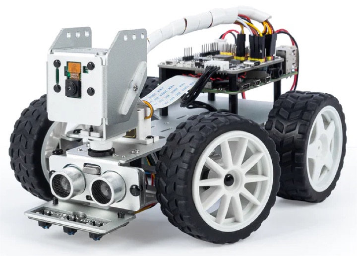 PiCar-X Raspberry Pi robot car with rugged tires, pan-tilt camera head and ultrasonic module on a white background.